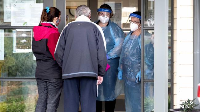 Family members arrive to visit a loved one at Doutta Galla Aged Services in Yarraville Village, Melbourne on Sunday. Picture: David Geraghty