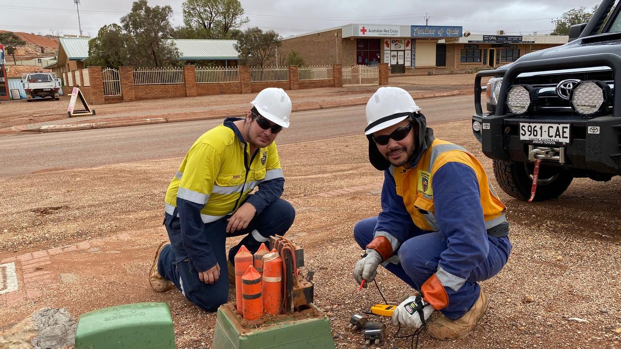 Council workers Brett Gardiner and Martin Grava repairing storm damage to the town’s electrical infrastructure. Picture: Dean Miller