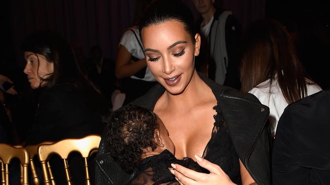 PARIS, FRANCE - SEPTEMBER 28: Kim Kardashian and baby North West attend the Givenchy show as part of the Paris Fashion Week Womenswear Spring/Summer 2015 on September 28, 2014 in Paris, France. (Photo by Pascal Le Segretain/Getty Images)