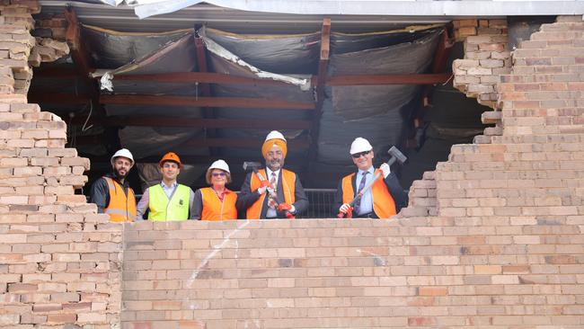 Blacktown Mayor Stephen Bali and councillors Moninder Singh and Kathie Collins join demolition contractors to mark the completion of stage one of the Warrick Ln redevelopment. Picture: Supplied