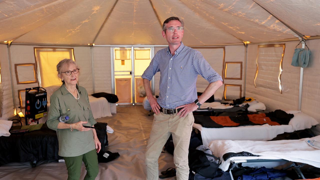 NSW Premier Dominic Perrottet at Wollongbar TAFE near Lismore, which has been set up as a tent city to house hundreds of RFS and Fire and Rescue personnel, with local member Janelle Saffin. Picture: Toby Zerna