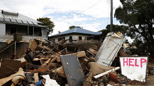 News Awards 2022 finalist pictures.   DAILY TELEGRAPH MARCH 9, 2022. PLEASE CONTACT PIC EDITOR KRISTI MILLER BEFORE PUBLISHING. Help written on a growing pill of destroyed household items by the flooding Wilsons River, outside a home on Elliott Rd in South Lismore. Picture: Jonathan Ng