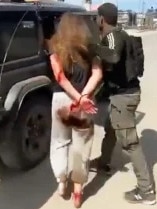 A still taken from video appearing on social media shows Ms Levy being taken prisoner by Palestinian militants.