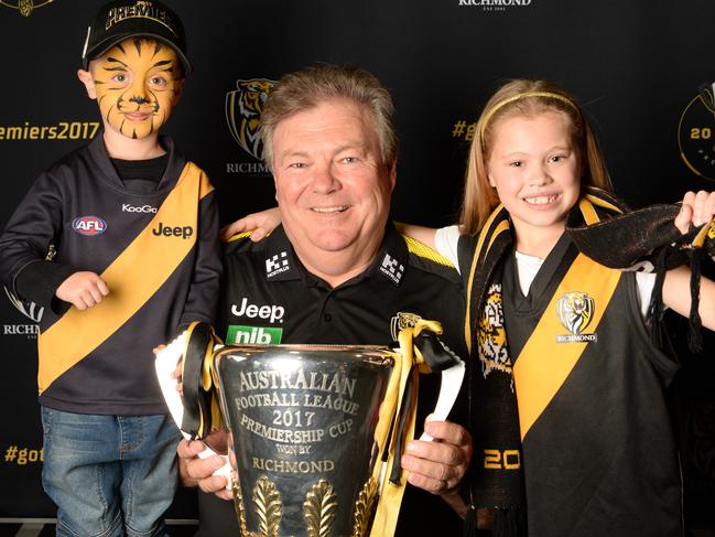 Neale Balme with Tiger fans Zac and Brianna and the 2017 trophy. Picture: Lawrence Pinder