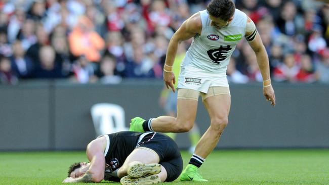 Marc Murphy leers over an injured Jake Carlisle. Picture: AAP