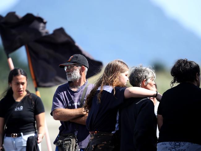 People are seen grieving and comforting one another on the Whakatane Wharf, New Zealand. Picture: Getty Images