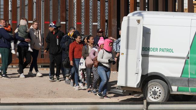 Venezuelan and Nicaraguan migrants are picked up in El Paso by the Texas Border Patrol after crossing the Rio Grande on Tuesday. Picture: AFP