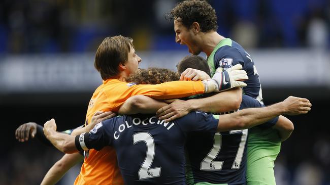 Newcastle's goalkeeper Tim Krul celebrates with Fabricio Coloccini and Daryl Janmaat, right, as his side win the English Premier League soccer match between Tottenham Hotspur and Newcastle United at White Hart Lane stadium in London, Sunday, Oct. 26, 2014. (AP Photo/Kirsty Wigglesworth)