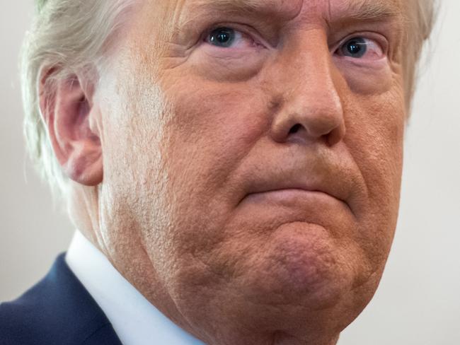 FILE:  US President Donald Trump looks on during a ceremony presenting the Presidential Medal of Freedom to wrestler Dan Gable in the Oval Office of the White House in Washington, DC on December 7, 2020. (Photo by SAUL LOEB / AFP)