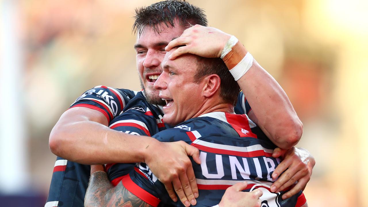 Angus Crichton of the Roosters celebrates scoring a try with captain Jake Friend, who injured his biceps during the game.