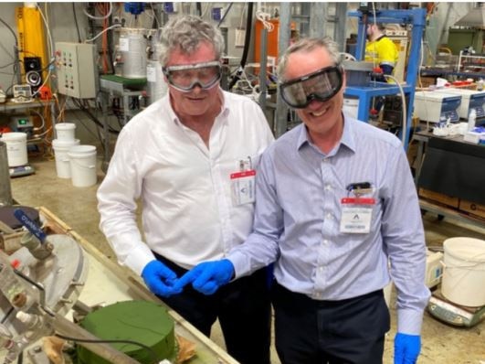 Queensland Pacific Metals executive director John Downie and managing director Stephen Grocott with the company's first nickel-cobalt product produced at a pilot plant in Perth, in 2021.