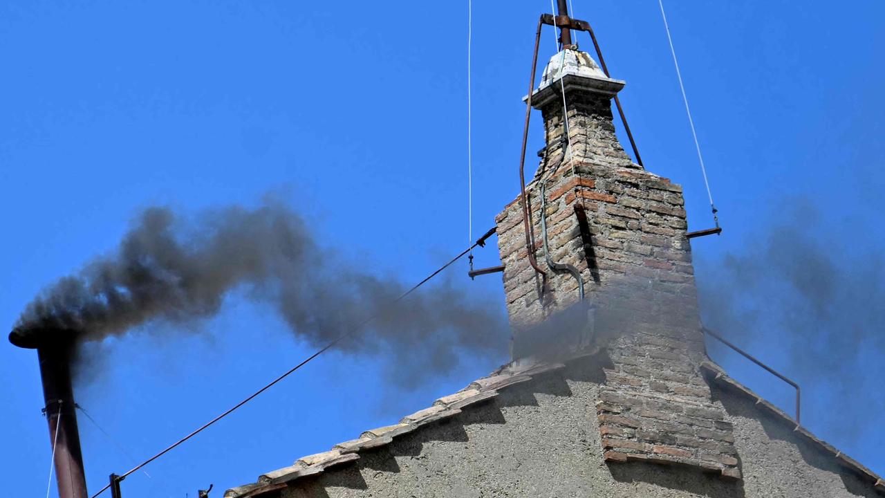 This photograph shows black smoke rising from the chimney of the Sistine Chapel signalling that cardinals failed to elect a new pope during their conclave in the Vatican on May 8, 2025. (Photo by Alberto PIZZOLI / AFP)