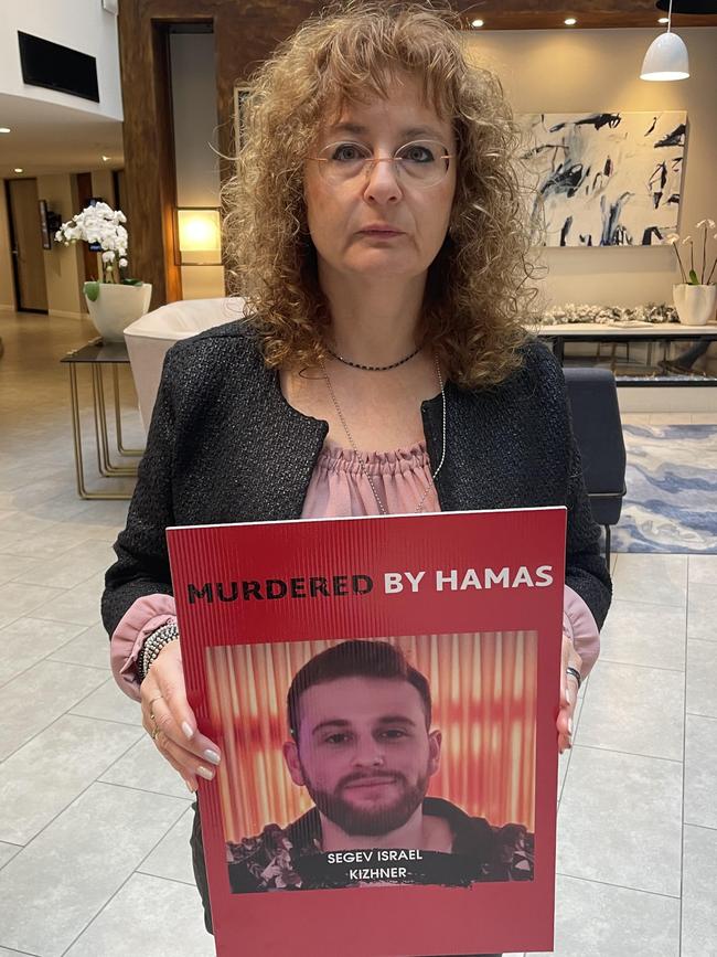 Mother Tali Kizhner with a poster of son Segev who was murdered by Hamas at Nova Music Festival.