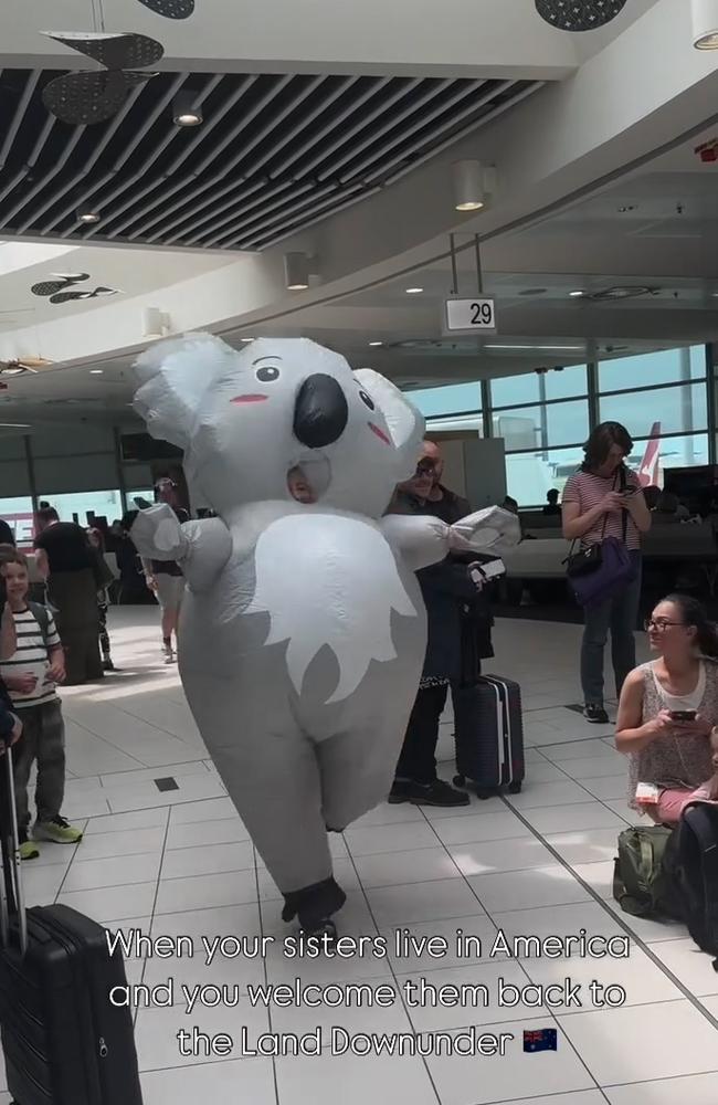 Janelle Spies runs through the Brisbane Domestic Airport as a koala to surprise her sisters in this screenshot from a now viral video. Picture: Supplied