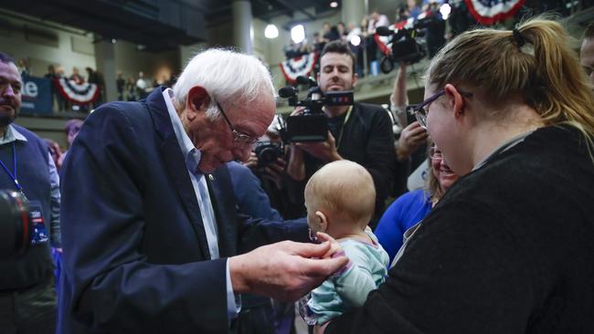 Bernie Sanders with Autumn Spence and her 6-month daughter Charlotte at a rally in Indianola, Iowa, on Sunday. Picture: AP