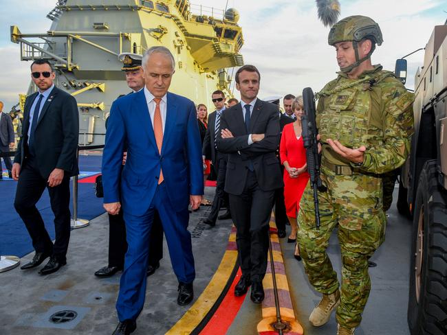 Australian Prime Minister Malcolm Turnbull (left) and President of France Emmanuel Macron (centre) meet with military personnel on the HMAS Canberra at Garden Island, in Sydney in 2018. Picture: AAP