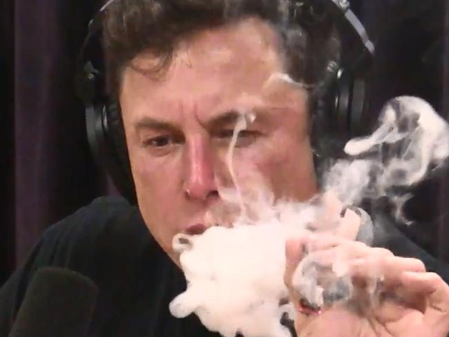 Tesla founder Elon Musk smokes a joint on the Joe Rogan Experience podcast.