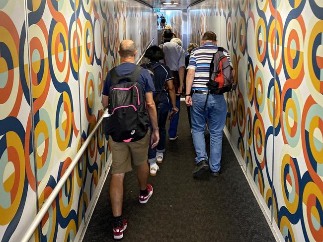 Passengers walk on a jet bridge after deboarding a British Airways flight headed to London at Budapest International Airport in Hungary after flights were grounded. Picture: Getty Images