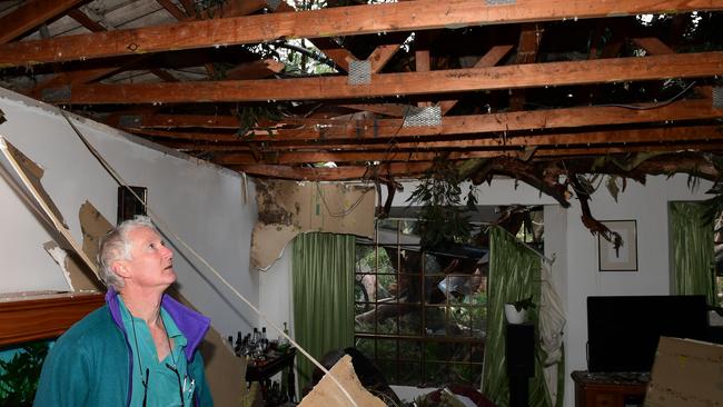 Simon Playfiar inspects the damage to his brother’s Aldgate house, which was crushed by falling trees in last night’s storms. Picture: Campbell Brodie