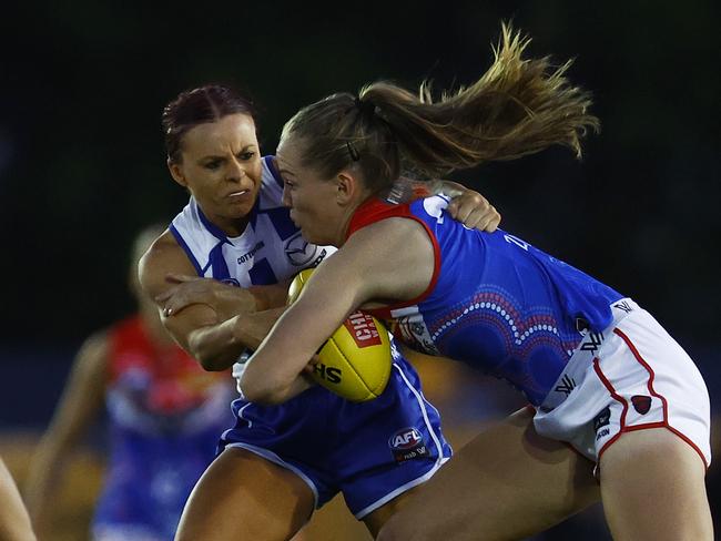 Eden Zanker (Melbourne) breaks a tackle from Jenna Bruton (North Melbourne) during the round eight AFLW match between the Demons and the Kangaroos. Picture: Getty Images