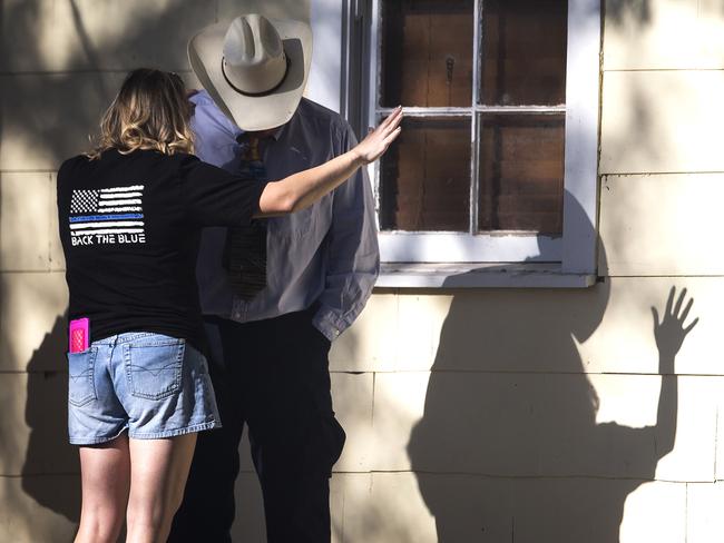 A woman prays with a man after a fatal shooting at the First Baptist Church in Sutherland Springs, Texas. Picture: AP