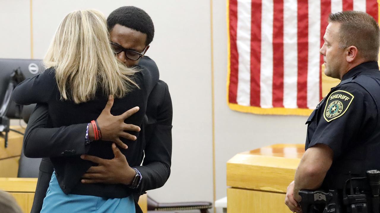 Botham Jean's younger brother Brandt Jean hugs convicted murderer and former Dallas police officer Amber Guyger. Picture: Tom Fox/The Dallas Morning News via AP