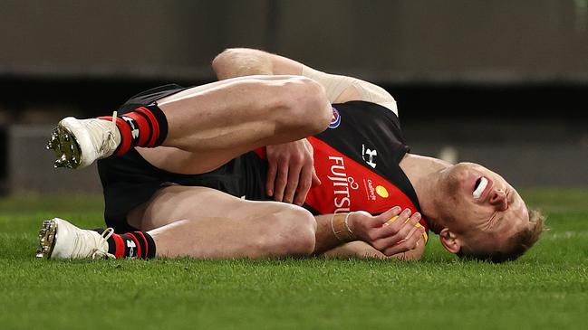 Essendon’s Nick Hind had a nasty collision with the behind post during his match against Melbourne. (Photo: Michael Klein)