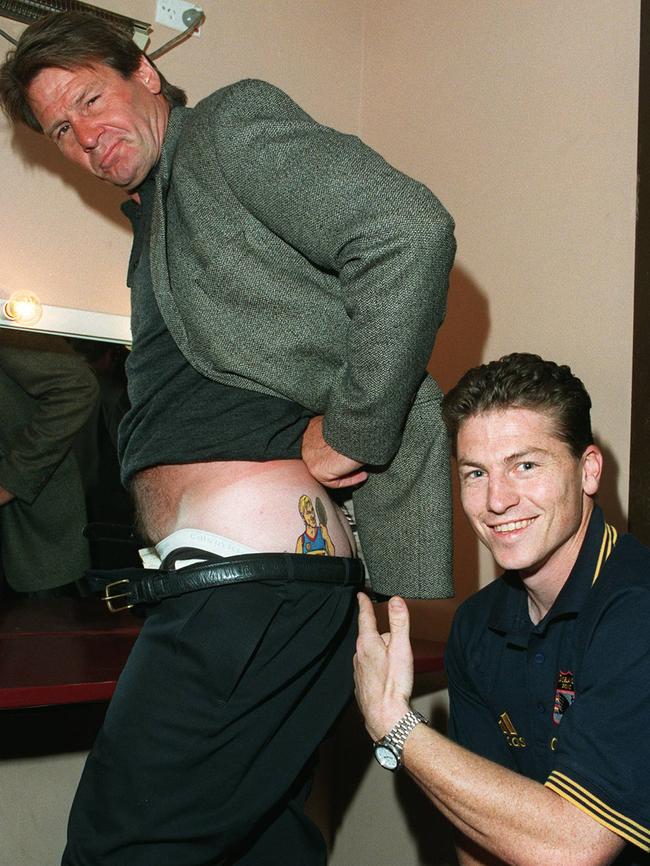 Former Adelaide captain Mark Bickley gets up close and personal with the tattoo of former teammate Tony Modra on Sam Newman’s butt. Picture: Dean Martin