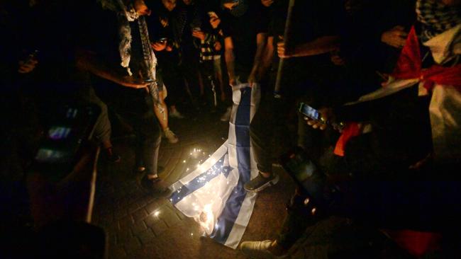 An Israeli flag is burned on October 9 outside the Opera House. Picture: Jeremy Piper