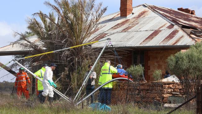 Police remove remains believed to be that of Robert Atkins from a water tank on a property during a search in the state’s Mid North. Picture: Riley Walter