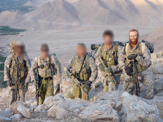 Corporal Mark Donaldson poses with Australian Special Forces above a valley in Afghanistan