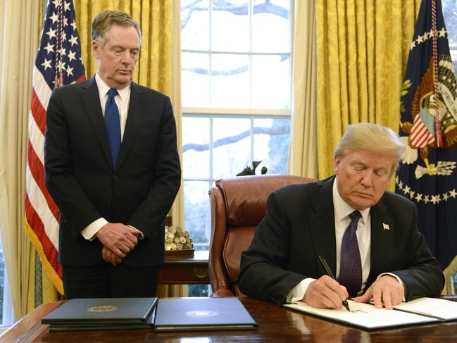 WASHINGTON, DC - JANUARY 23:  President Donald Trump makes remarks as he signs a Section 201 action as US Trade Representative Robert Lighthizer witnesses, in the Oval Office, at the White House, January 23, 2018, in Washington, DC. The administration is issuing tariffs on imported solar panels and washing machines to protect American manufacturing companies against dumping by foreign countries, mainly China, and including South Korea.   (Photo by Mike Theiler-Pool/Getty Images)