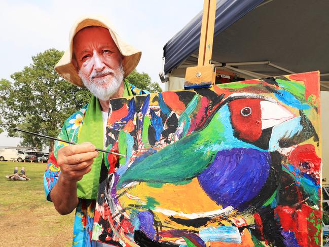 Artist Chris Degendhart with one of his striking paintings with will be for sale at the Murwillumbah Farmers Markets.