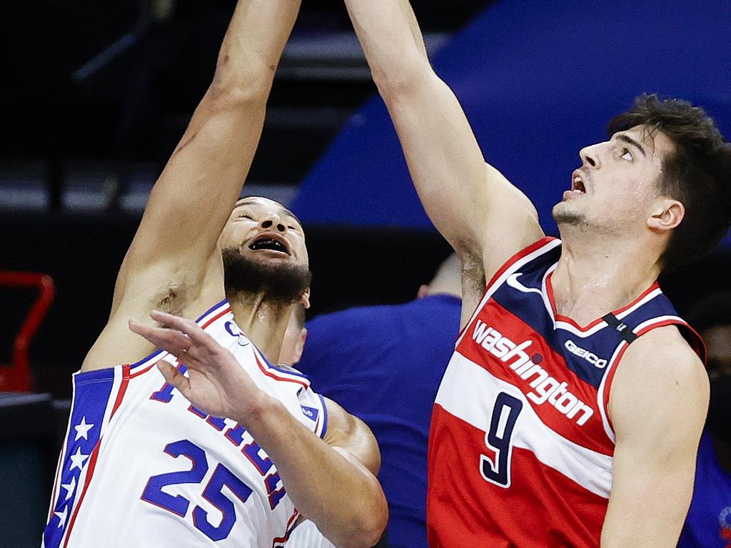 Ben Simmons competes with Deni Avdija for a rebound.