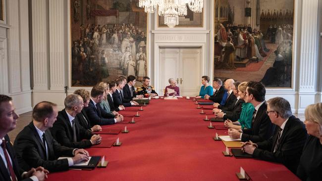 Queen Margrethe II hands over the crown during a Council of State with the Prime Minister and her cabinet. Picture: AFP