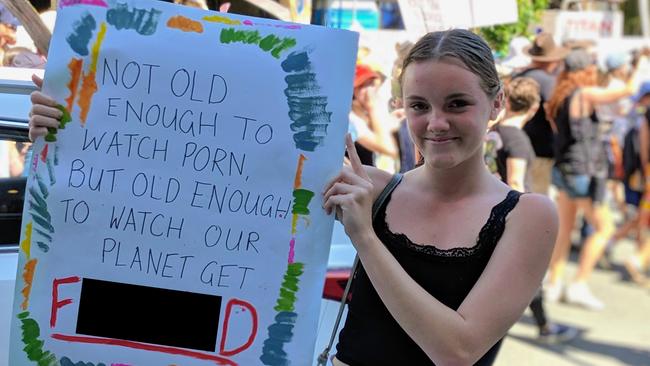 Palm Beach Currumbin State High student Georjie Stegman carried a sign reading “Not old enough to watch porn, but old enough to watch our planet get f---ed” at the Global Climate Strike at Broadbeach. Picture: Luke Mortimer