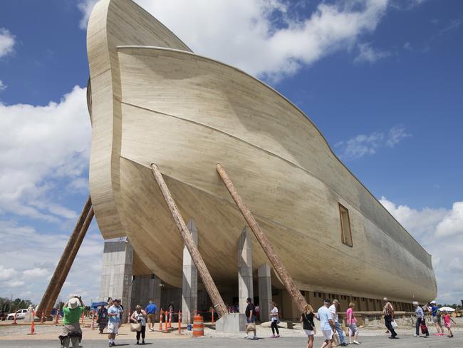 FILE - In this July 5, 2016, file photo, visitors pass outside the front of a replica Noah's Ark at the Ark Encounter theme park during a media preview day, in Williamstown, Ky. In the Bible, the ark survived an epic flood. Yet the owners of Kentuckyâ€™s Noahâ€™s ark attraction are demanding their insurance company rescue them from flooding that caused nearly $1 million in property damage. (AP Photo/John Minchillo, File)