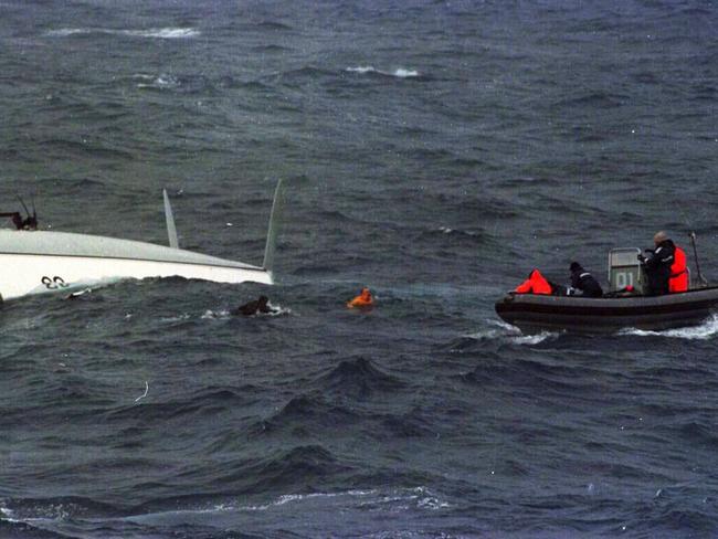 Missing yachtsman Tony Bullimore (R) emerges from beneath hull of upturned yacht Exide Challenger to meet crew of frigate HMAS Adelaide 09/01/97, at centre of air-sea rescue in Southern Ocean off Perth whilst competing in Vendee Global solo round world race./yachting  /accidents