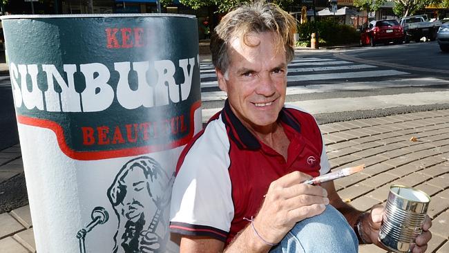 Artist Phil Roberts with one of his two painted bollards on O’Shanassy St.