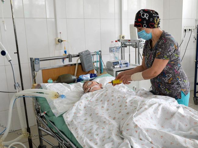 A doctor takes care of a boy, who was injured by the shelling in a hospital in Ukraine's second-biggest city of Kharkiv. Picture: AFP