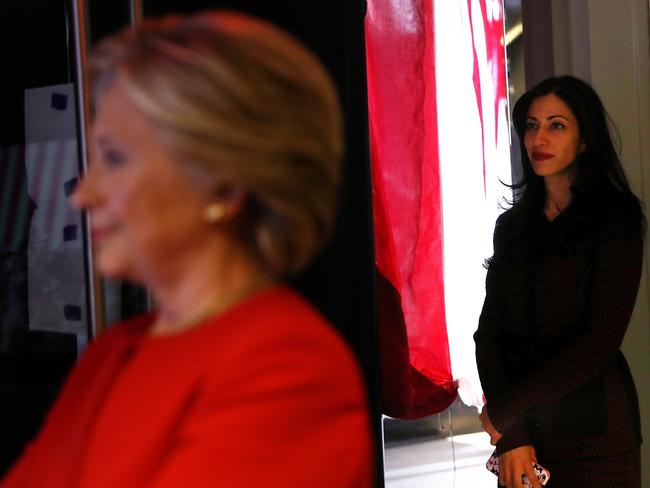 Hillary Clinton (left) and her longtime aide Huma Abedin stand backstage at a campaign rally in North Carolina. Picture: Justin Sullivan/Getty Images/AFP