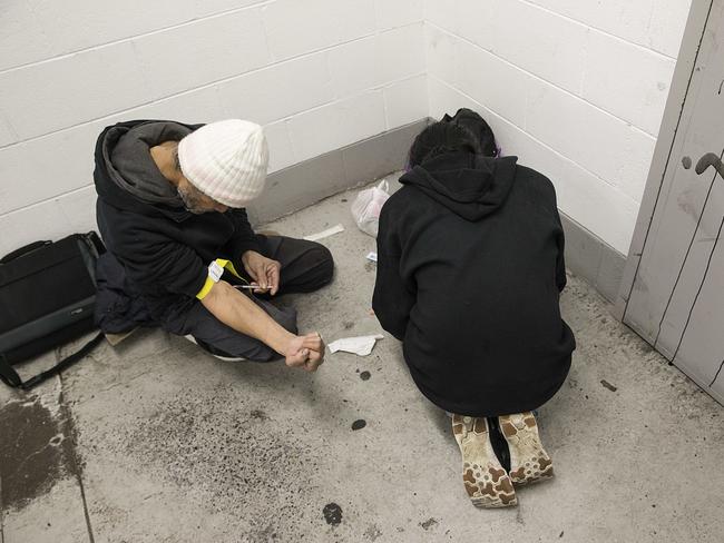 Vinnie injects heroin in a stairwell within the carpark. Picture: Ian Currie