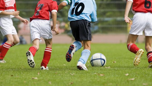 soccer game with four players in action