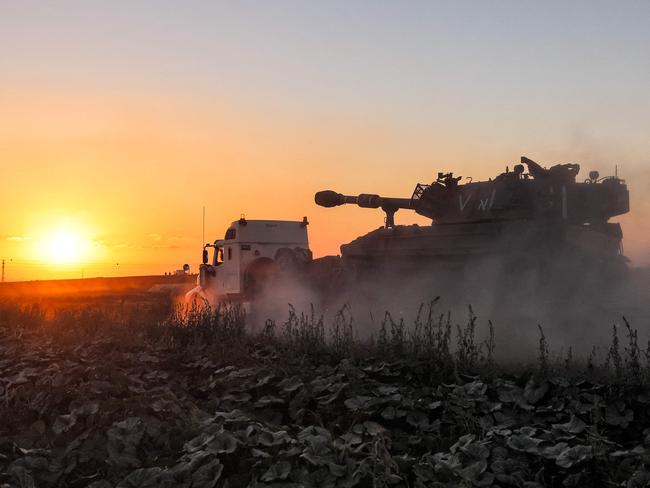 An Israeli 155mm self-propelled howitzer, loaded on a trailer, arrives at a position along the Israel-Gaza border. Picture: Emmanuel Dunand / AFP