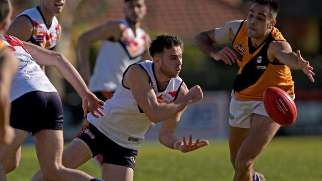 EDFL: East Keilor’s Mark Mazzeo fires out a handball. Picture: Andy Brownbill