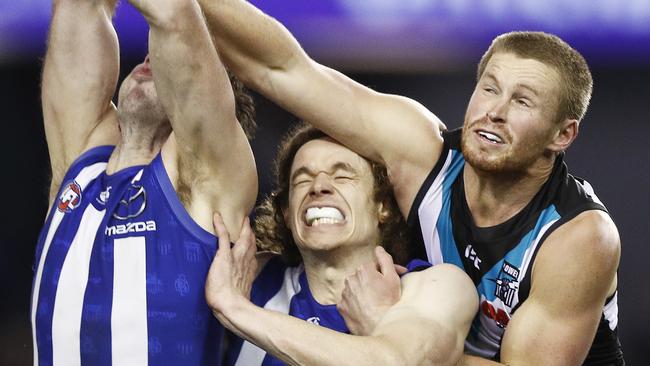 (L-R) Todd Goldstein of the Kangaroos, Ben Brown of the Kangaroos and Tom Clurey of the Power contest the ball during the Round 22 AFL match between the North Melbourne Kangaroos and the Port Adelaide Power at Marvel Stadium in Melbourne, Saturday, August 17, 2019.  (AAP Image/Daniel Pockett) NO ARCHIVING, EDITORIAL USE ONLY