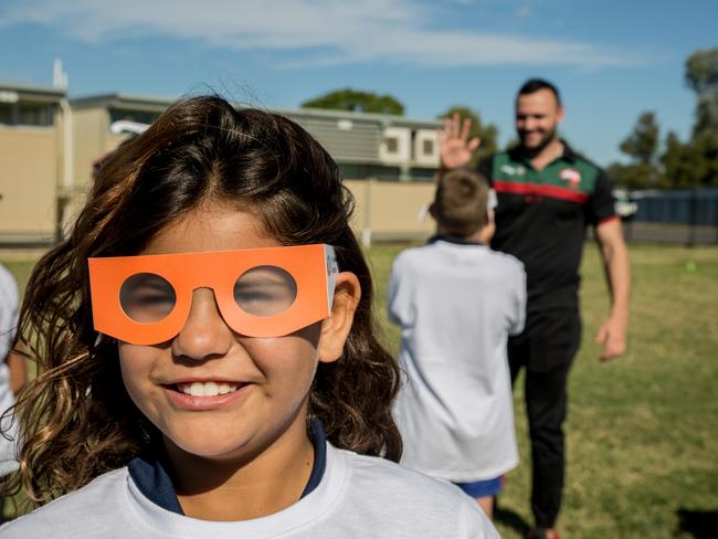 Bourke Public School student Shanorah tries out cataract glasses during a Souths Cares rugby league clinic in support of The Fred Hollows Foundation and the Outback Eye Service.