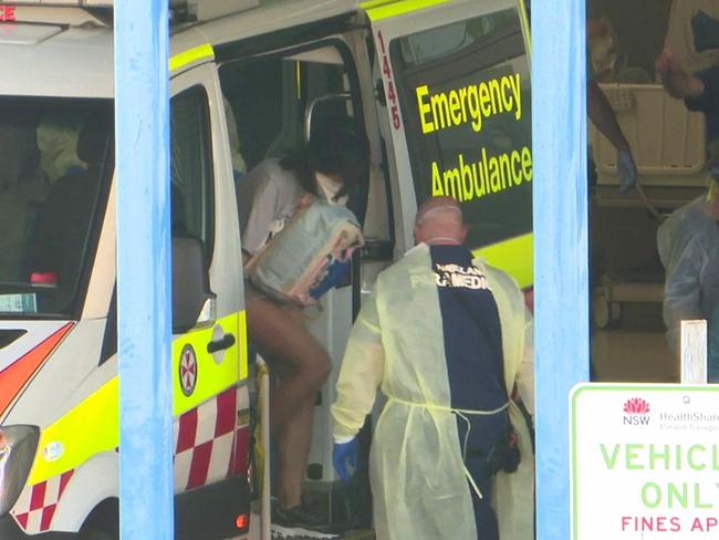 A 21-year-old female arrives at Sydney's Westead Hospital after testing positive for coronavirus. Picture: TNV