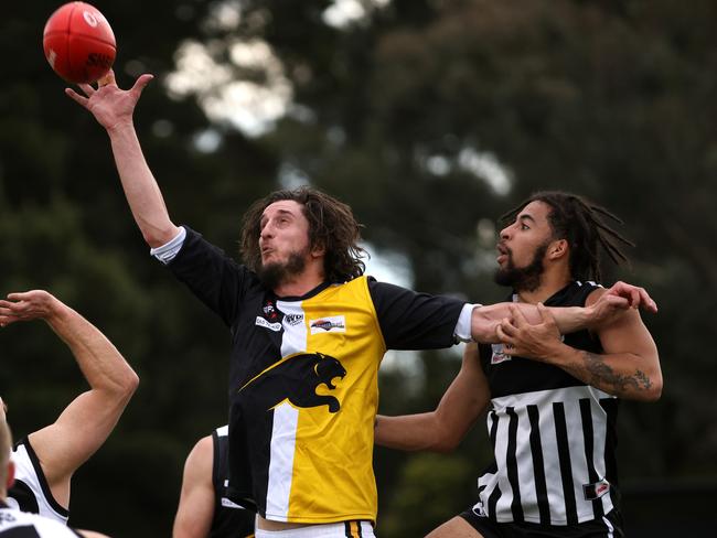 EFL: Chirnside Park’s Grattan Stephens battles Jara Oburu of Surrey Park in the ruck. Photo: Hamish Blair