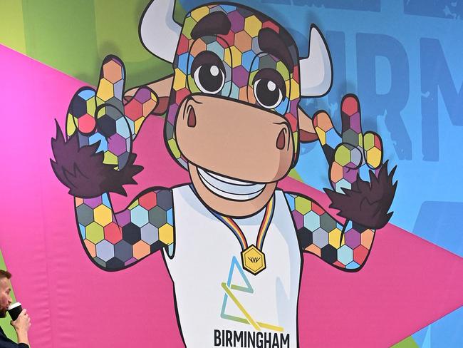 A pedestrian walks past Commonwealth Games branding, including Perry the games mascot, in Birmingham, central England, on July 26, 2022, ahead of the Commonwealth Games. - The Commonwealth Games is set to run from July 28 to August 8. (Photo by Paul ELLIS / AFP)